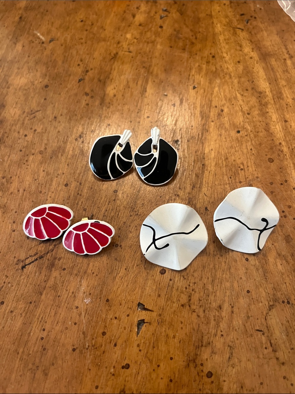 Three pairs of metal stud earrings